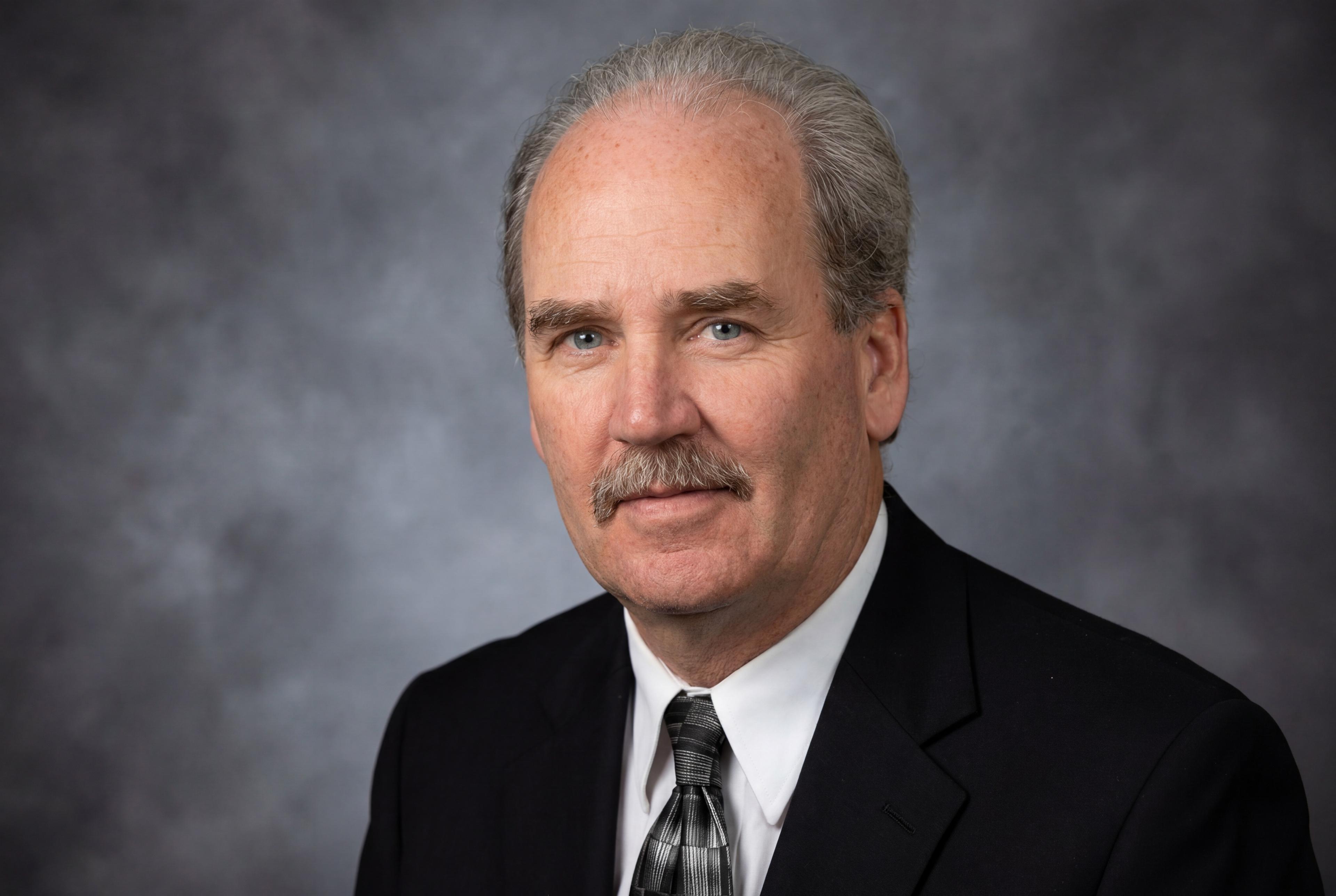 Mike King, London Ontario real estate agent, in a dark suit and tie